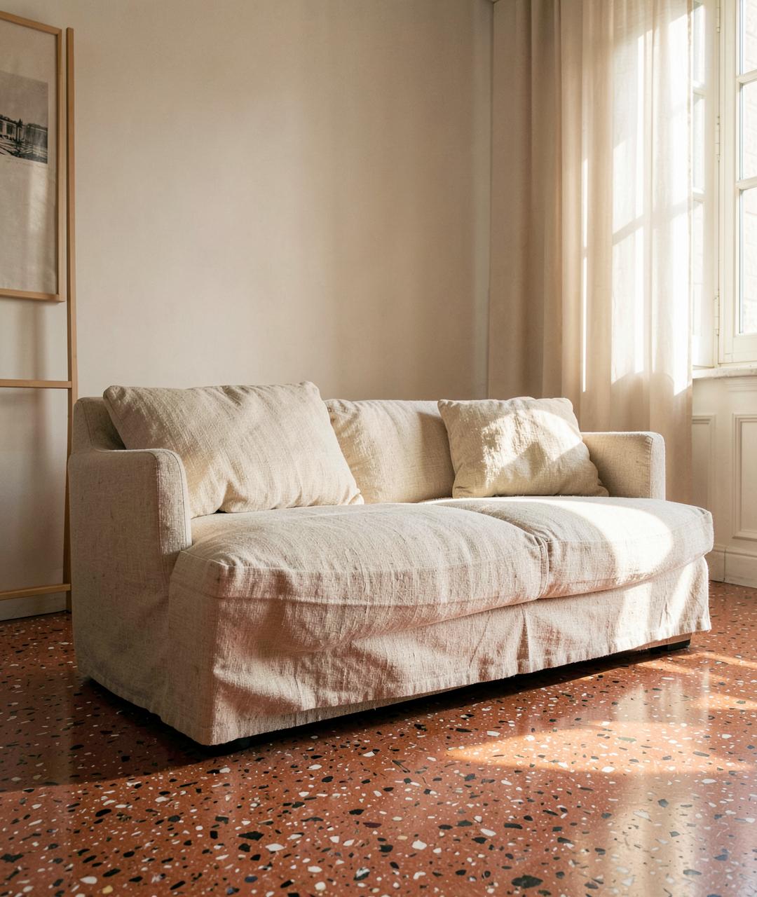 Sunlit linen sofa on a terracotta terrazzo floor
